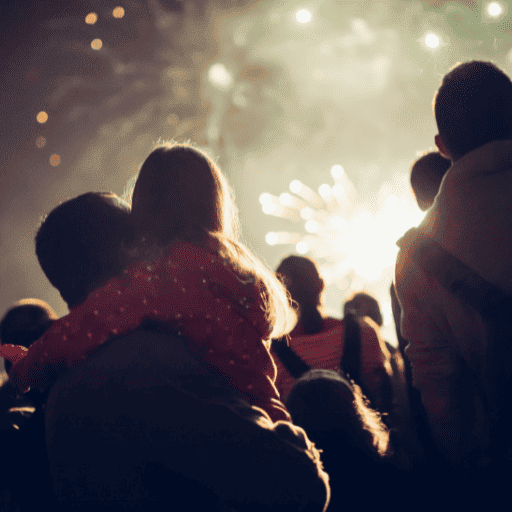 family watching a firework show where the dad is holding his daughter