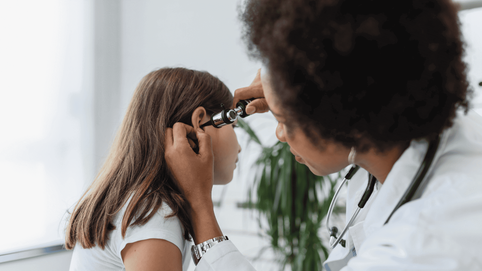 girl holding her hands over her ears. side profile view