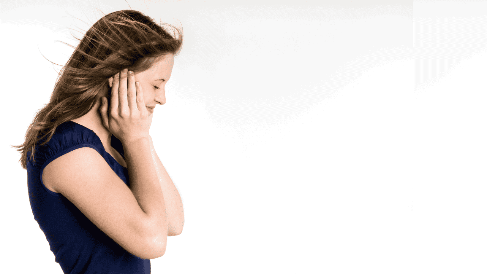 girl holding her hands over her ears. side profile view