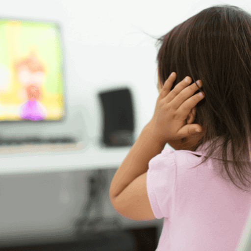 Little girl with autism in a pink short sleeve shirt covering her ears because of a sound sensitivity