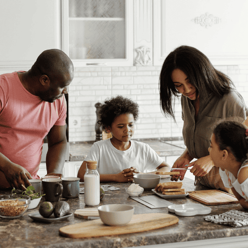 family talking while preparing a meal at the kitchen island