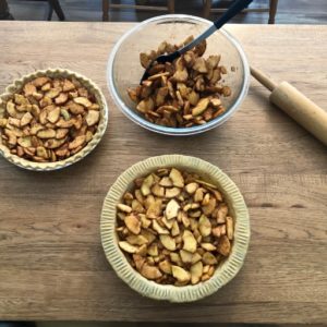 Putting cinnamon spice sliced apples in pie shell